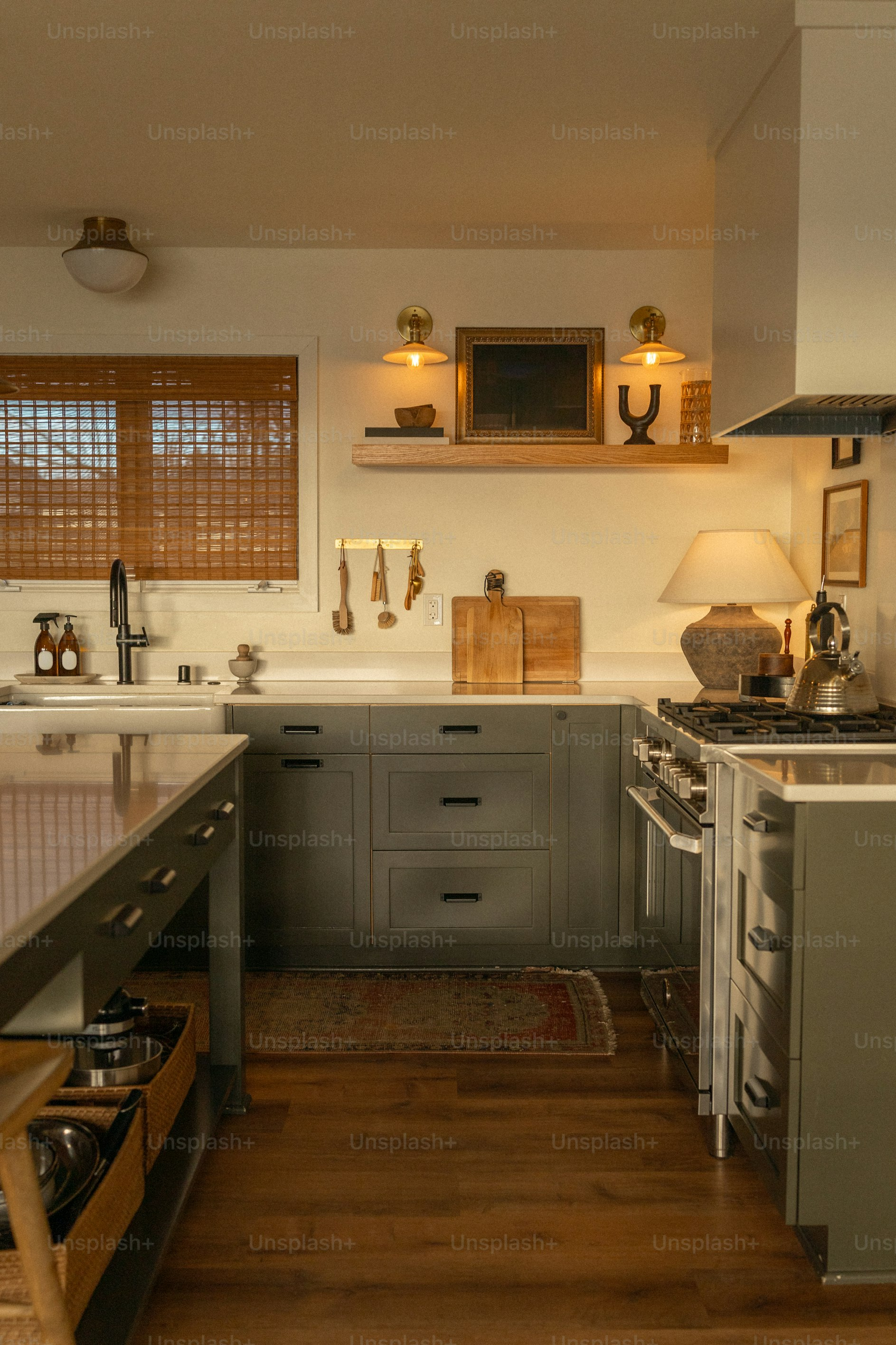 A kitchen with a stove, sink, and cabinets